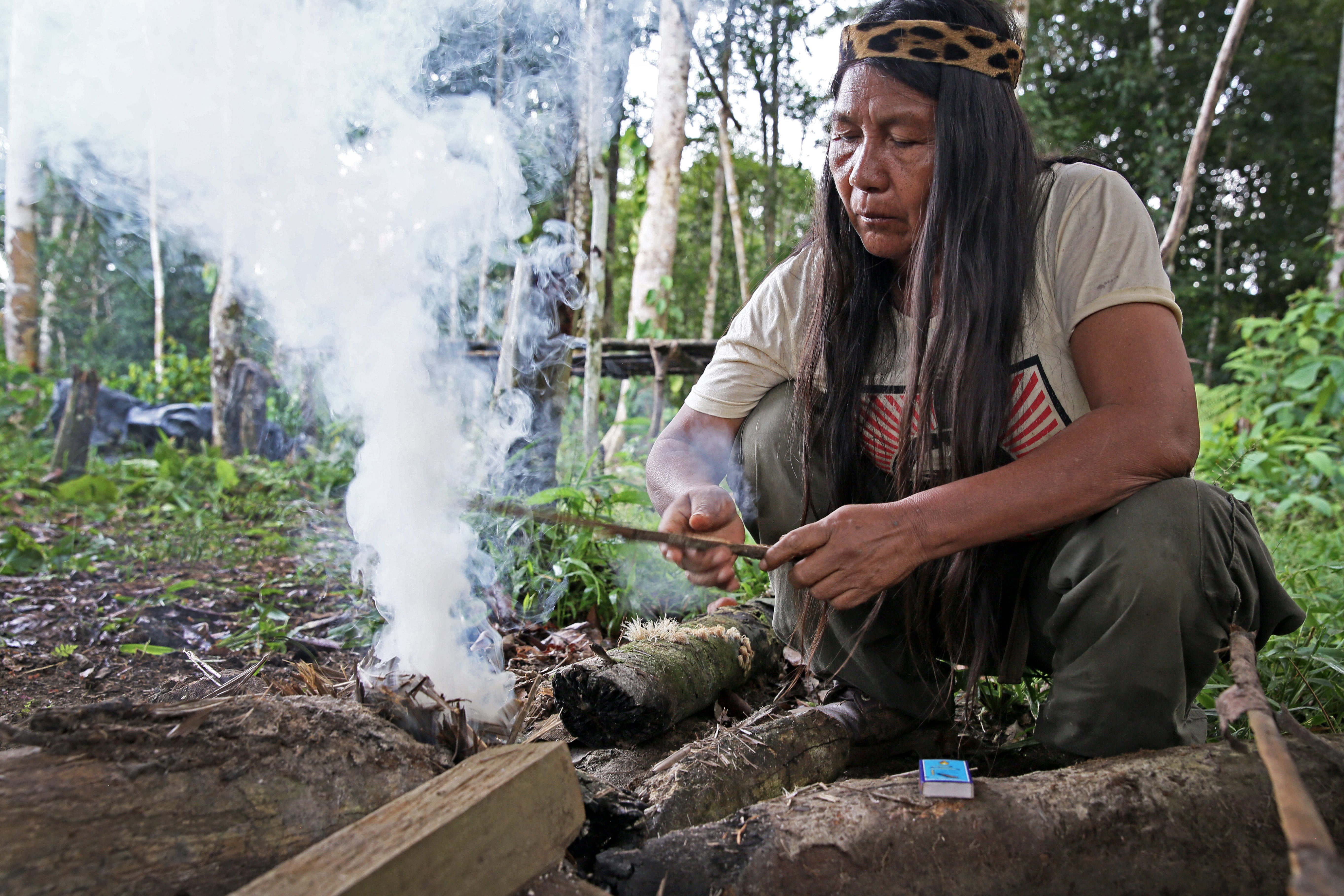 Amazon rainforest reflected in rainwater filling a Sápara dugout canoe, Ecuador. Photo © Gleb Raygorodetsky