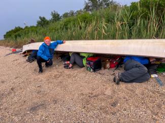 Crew members stopping on a small island to wait out Thunder and Lightening. Photo but Chenae Bullock_