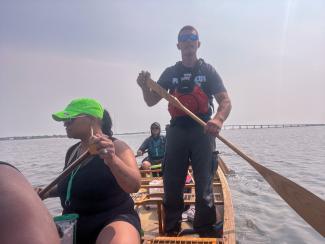 Paddling in shallow waters of the Shinnecock Bay, Ryan Ranco Kelly stands up to see look ahead. Photo taken by Chenae Bullock